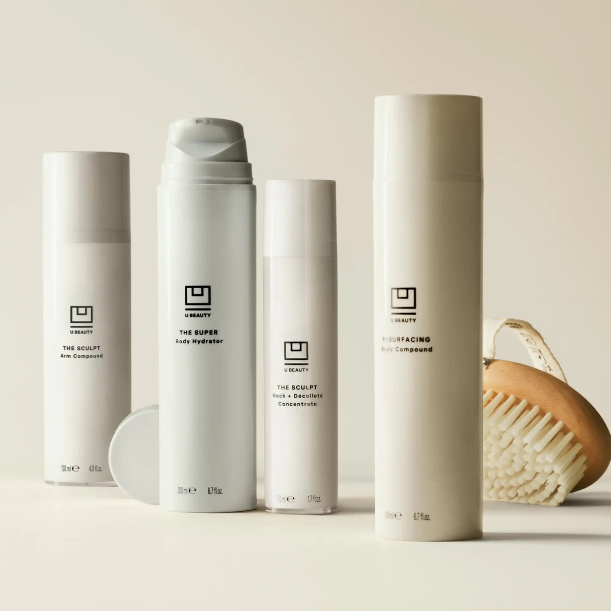 Set of skincare products with a brush on a neutral background