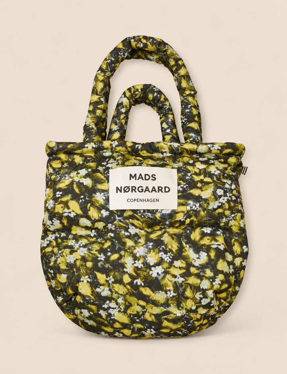 Mads Nørgaard Light Ripstop Pillow AOP Bag in Flora AOP, an oversized floral puffer tote with padded handles and a lightweight recycled polyester design.