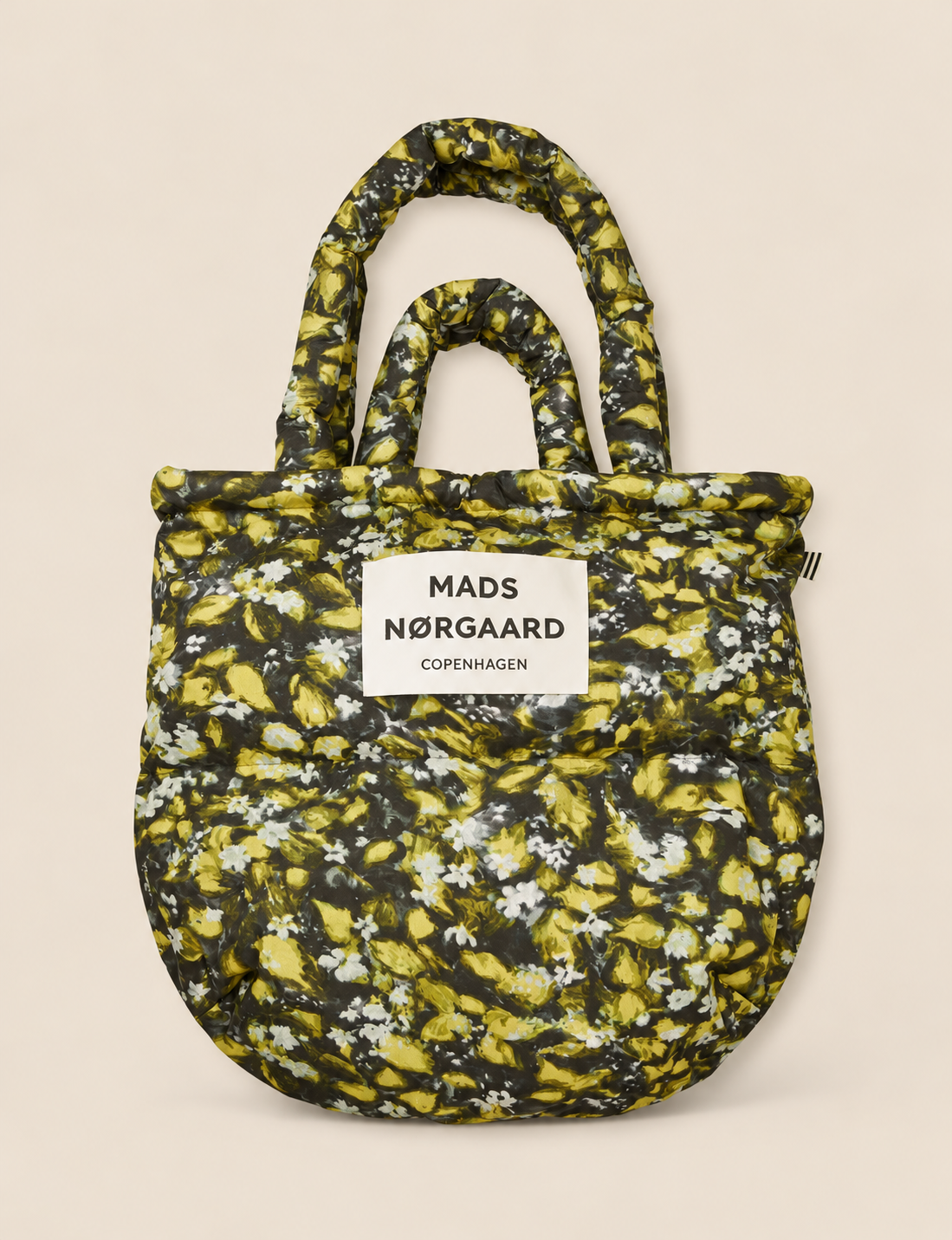Mads Nørgaard Light Ripstop Pillow AOP Bag in Flora AOP, an oversized floral puffer tote with padded handles and a lightweight recycled polyester design.