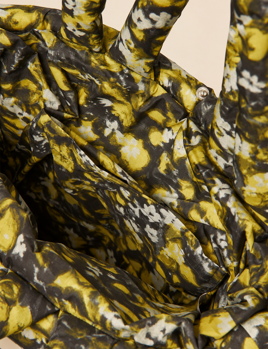 Interior detail of the Mads Nørgaard Flora AOP Pillow Bag featuring a spacious main compartment and convenient inside pocket.