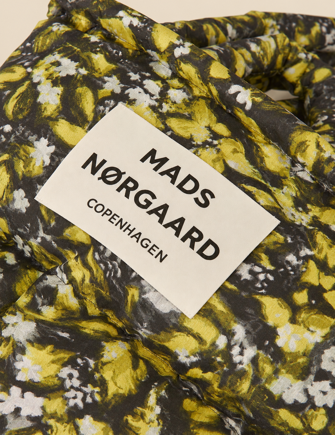 Flora AOP floral print detail on the Mads Nørgaard Light Ripstop Pillow Bag, showing the padded fabric and distinctive all-over pattern.