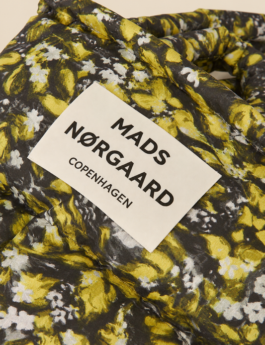 Flora AOP floral print detail on the Mads Nørgaard Light Ripstop Pillow Bag, showing the padded fabric and distinctive all-over pattern.